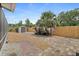 Backyard with paver and gravel walkway, storage shed, and wood fence at 809 E 14Th Ave, New Smyrna Beach, FL 32169