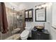 Bathroom with glass enclosed shower, mosaic tile accents, dark vanity and custom decorative sink at 809 E 14Th Ave, New Smyrna Beach, FL 32169