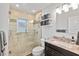 Bathroom with a glass enclosed shower, mosaic tile accents, granite vanity and updated fixtures at 809 E 14Th Ave, New Smyrna Beach, FL 32169