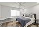 Bright bedroom with a large window, ceiling fan, wood floors and desk area for your convenience at 809 E 14Th Ave, New Smyrna Beach, FL 32169