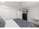 Bedroom featuring a ceiling fan, dresser with television and closet space for your organizational needs at 809 E 14Th Ave, New Smyrna Beach, FL 32169
