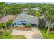 Charming exterior with brick driveway, well-maintained landscaping, and a carport at 809 E 14Th Ave, New Smyrna Beach, FL 32169