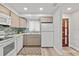 Well-lit kitchen with stainless steel appliances, gray cabinets, and a beautiful backsplash above the granite countertops at 809 E 14Th Ave, New Smyrna Beach, FL 32169