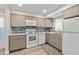 Stylish kitchen featuring stainless steel appliances, grey cabinets, and a lovely backsplash with granite countertops at 809 E 14Th Ave, New Smyrna Beach, FL 32169