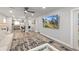 Spacious living room with a breakfast bar, kitchen, and a large flat-screen TV above an area rug at 809 E 14Th Ave, New Smyrna Beach, FL 32169