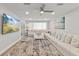 Modern living room featuring a ceiling fan, recessed lighting, a TV, a large area rug, and comfortable seating at 809 E 14Th Ave, New Smyrna Beach, FL 32169