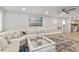 Spacious living room featuring a large sectional sofa, modern ceiling fan and access to the kitchen at 809 E 14Th Ave, New Smyrna Beach, FL 32169