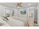 This bedroom offers a view of the backyard screened pool through French doors and a ceiling fan at 809 E 14Th Ave, New Smyrna Beach, FL 32169