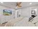 Spacious main bedroom boasts an en suite bathroom, ceiling fan and TV with mountain view at 809 E 14Th Ave, New Smyrna Beach, FL 32169