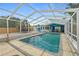 Screened pool with ladder and paver deck, providing a private backyard retreat at 809 E 14Th Ave, New Smyrna Beach, FL 32169