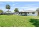 Spacious backyard with lush green grass and a charming white home, perfect for outdoor activities at 825 Wells Dr, South Daytona, FL 32119