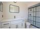 Modern bathroom with white vanity, quartz countertop, sleek fixtures, and a glass-enclosed shower at 825 Wells Dr, South Daytona, FL 32119