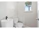 This bathroom features a unique sink and a window offering a view of a palm tree outside at 825 Wells Dr, South Daytona, FL 32119