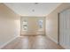 Empty bedroom with neutral walls, two windows, and wood-look flooring, ready for personalization at 825 Wells Dr, South Daytona, FL 32119