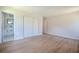 Spacious bedroom with neutral walls, wood-look flooring, and a closet with double doors at 825 Wells Dr, South Daytona, FL 32119