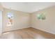 Empty bedroom with neutral walls, two windows, wood-look flooring, and natural light at 825 Wells Dr, South Daytona, FL 32119