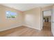 Bright bedroom featuring wood-look floors and a window overlooking the green outdoors at 825 Wells Dr, South Daytona, FL 32119