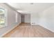 Bright living room with hardwood flooring, white walls, and plenty of natural light at 825 Wells Dr, South Daytona, FL 32119