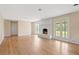 Open-concept living room with fireplace, neutral walls, and wood floors, leading to the outdoors at 825 Wells Dr, South Daytona, FL 32119