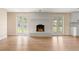 Spacious living room with a painted brick fireplace flanked by doors to the outdoor living space at 825 Wells Dr, South Daytona, FL 32119