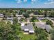 The aerial view captures the property nestled in a serene neighborhood with mature trees and a nearby lake at 832 Wildwood Cir, Port Orange, FL 32127