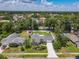 This aerial view highlights the property with its well-maintained yard, mature trees, and the surrounding residential area at 832 Wildwood Cir, Port Orange, FL 32127
