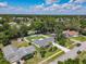Aerial view showcasing the property with a large backyard, privacy fence, shed, and proximity to neighborhood amenities at 832 Wildwood Cir, Port Orange, FL 32127