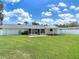 A large grassy backyard offers an outdoor living space and a fenced-in perimeter at 832 Wildwood Cir, Port Orange, FL 32127