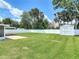 A spacious, fenced-in backyard is complete with a storage shed and lush, green grass at 832 Wildwood Cir, Port Orange, FL 32127