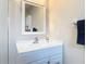 Bright bathroom features a vanity with a mirror and towel rack with decorative towel at 832 Wildwood Cir, Port Orange, FL 32127