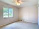 Bedroom featuring a window with natural light, carpet, and plain white walls at 832 Wildwood Cir, Port Orange, FL 32127
