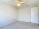 Bedroom with a ceiling fan and a door enhancing the space at 832 Wildwood Cir, Port Orange, FL 32127