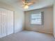Bedroom featuring a window, ceiling fan, and a closet, providing ample storage at 832 Wildwood Cir, Port Orange, FL 32127