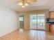 Dining room featuring access to the enclosed patio and a convenient pass-through to the kitchen at 832 Wildwood Cir, Port Orange, FL 32127