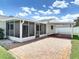 An exterior home view showcases a screened porch, patio, and well-maintained landscaping at 832 Wildwood Cir, Port Orange, FL 32127