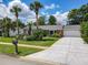 Charming single-story brick home with a lush lawn, mature landscaping, and a pristine driveway at 832 Wildwood Cir, Port Orange, FL 32127