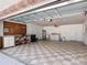 Spacious garage with checkered tile flooring, workbench, and utility sink at 832 Wildwood Cir, Port Orange, FL 32127