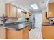 Well-lit kitchen featuring granite counters, stainless steel appliances, and tile flooring at 832 Wildwood Cir, Port Orange, FL 32127