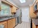 Well-lit kitchen features stainless steel appliances, light wood cabinetry, and tile flooring at 832 Wildwood Cir, Port Orange, FL 32127