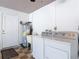 Laundry room with washer, dryer, utility sink, and water heater at 832 Wildwood Cir, Port Orange, FL 32127