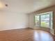 Bright room featuring hardwood floors, neutral walls, and a large bay window overlooking the yard at 832 Wildwood Cir, Port Orange, FL 32127