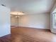 Spacious living room featuring hardwood floors, natural light from bay window, and mirrored wall at 832 Wildwood Cir, Port Orange, FL 32127