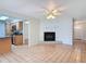 Open living room with tile floors, brick fireplace and seamless access to the kitchen at 832 Wildwood Cir, Port Orange, FL 32127