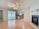 Bright living room featuring a painted brick fireplace and open access to the kitchen at 832 Wildwood Cir, Port Orange, FL 32127