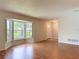Bright living room featuring hardwood floors, neutral walls, and a large bay window with natural light at 832 Wildwood Cir, Port Orange, FL 32127