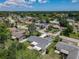 The aerial view captures the property nestled in a serene neighborhood with mature trees and a nearby lake at 832 Wildwood Cir, Port Orange, FL 32127
