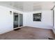 Enclosed patio with white walls, sliding glass doors, and carpet flooring at 832 Wildwood Cir, Port Orange, FL 32127