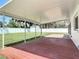 An outdoor covered patio with painted flooring and brick pavers with a yard view at 832 Wildwood Cir, Port Orange, FL 32127