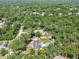 Aerial view of a single-Gathering home with pool and RV parking on a treed lot at 851 W Wisconsin Ave, Orange City, FL 32763