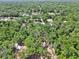 An aerial view showcasing the lush surrounding foliage and neighborhood at 851 W Wisconsin Ave, Orange City, FL 32763